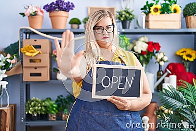 Caucasian plus size woman working at florist holding open sign with open hand doing stop sign with serious and confident Stock Photo