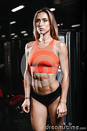 Caucasian fitness female model in gym close up abs Stock Photo