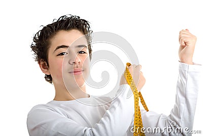 Caucasian smooth-skinned boy measuring muscle with meter tape Stock Photo