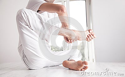 Caucasian sports man doing body activity in office Stock Photo