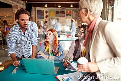 Caucasian team, different ages, consulting about new ideas in marketing agency Stock Photo