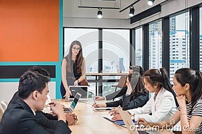 Caucasian team leader and multiethnic business colleagues meeting with seriously about the future business plan of modern office Stock Photo