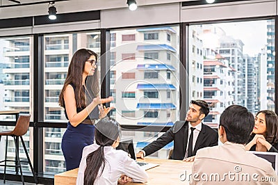 Caucasian team leader and multiethnic business colleagues meeting with seriously about the future business plan of modern office Stock Photo