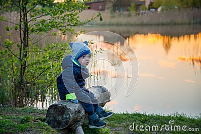 Caucasian toddle boy outdoors near lake in spring Stock Photo