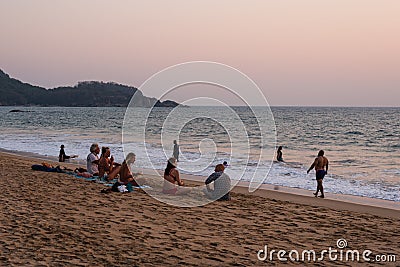 Caucasian Tourists and families relaxing and enjoying on the beach at Agonda Beach in Goa, India Editorial Stock Photo