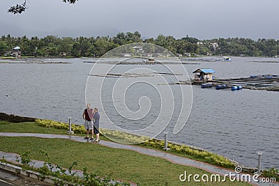 Caucasian tourists visit improvised house shanty built on a lake Editorial Stock Photo