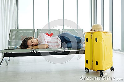 Caucasian traveler woman is sleeping on passenger While waiting to travel by plane in airport. à¹‹Jouney and travel for business Stock Photo