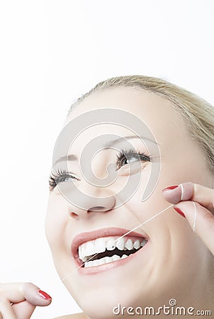 Caucasian Woman Flossing Teeth and Smiling. Dental Care and Oral Stock Photo