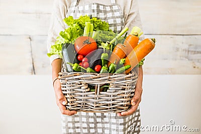 Caucasian woman people with bucket full of coloured and mixed fresh healthy food like fruit and vegetables Stock Photo