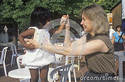 A Caucasian woman playing with an Indian child, Editorial Stock Photo
