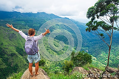 Caucasian woman standing and looking on mountain and valley. Stock Photo