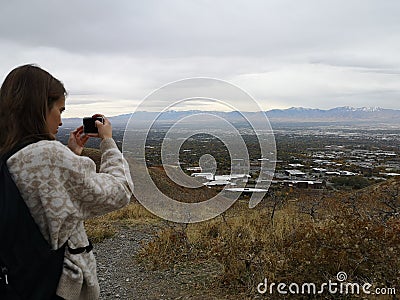 Caucasian woman taking a photo to the view from Living Room Trailhead hike Stock Photo