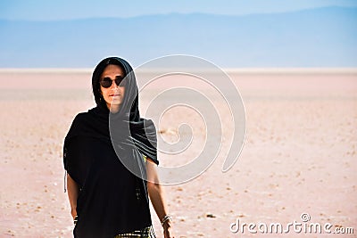 Caucasian woman tourist stand on Maharlu pink salt lake shore. Travel destination Iran in Shiraz Stock Photo