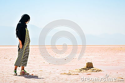 Caucasian woman tourist stand on Maharlu pink salt lake shore. Travel destination Iran in Shiraz Stock Photo