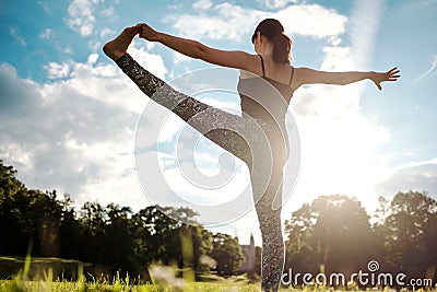 Caucasian woman in yoga standing balance Utthita Hasta Padangusthasana pose. Back view Stock Photo