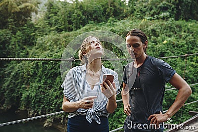 Caucasian woman and man having a bad cellular signal in the nature travel problem concept Stock Photo