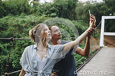 Caucasian woman and man taking a selfie outdoors recreational leisure, freedom and adventure concept Stock Photo