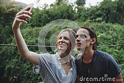 Caucasian woman and man taking a selfie outdoors recreational leisure, freedom and adventure concept Stock Photo