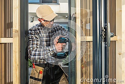 Caucasian Worker Installing Aluminium Made Window Inside a Wall Stock Photo