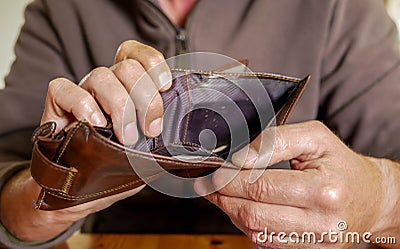 Caucasian worker with a missing finger showing hes empty wallet Stock Photo