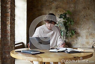 Caucasian young man using credit card and laptop for online shopping. Stock Photo