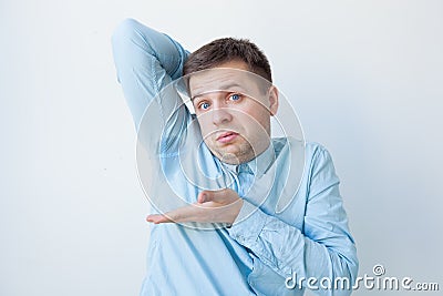 Caucasian, young man is worried and shows sweating stain Stock Photo