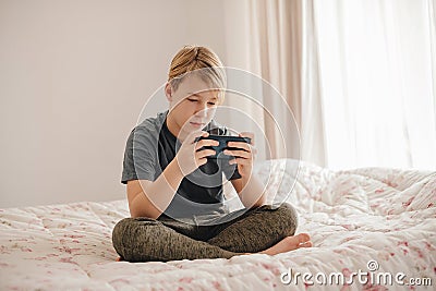 Caucasina boy holding a phone Stock Photo