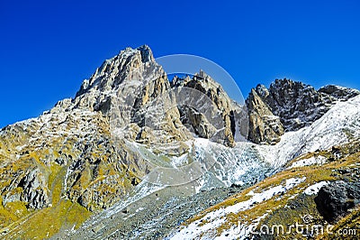 Caucasus Mountains, village Juta. green hill, blue sky, and snowy peak Chaukhebi in summer. Stock Photo