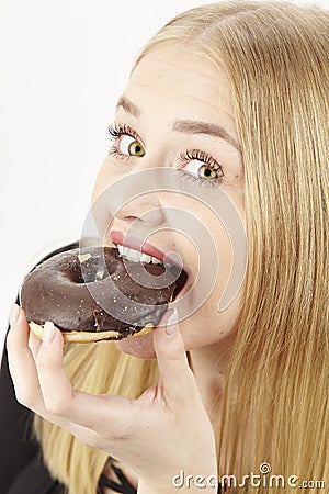 Caught - she eats a donut Stock Photo