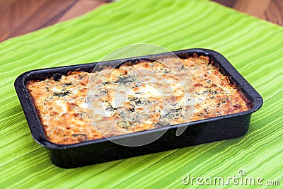 Cauliflower baked with eggs, cheese and parsley Stock Photo