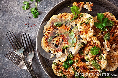 cauliflower steaks with herb sauce and spice. plant based meat substitute Stock Photo