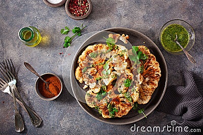 Cauliflower steaks with herb sauce and spice. plant based meat substitute Stock Photo