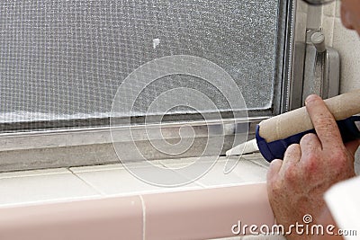 Caulking a Bathroom Window Frame Stock Photo