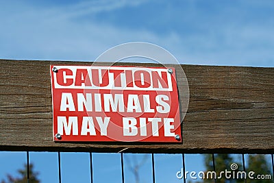 Caution animals may bite sign Stock Photo