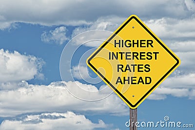 Caution Sign Blue Sky - Higher Interest Rates Stock Photo