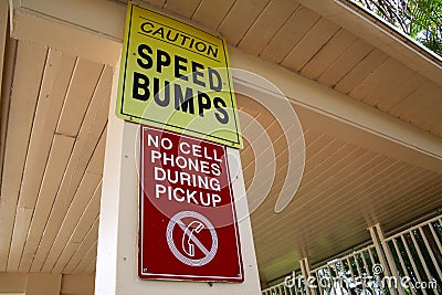 Caution Speed Bumps No Cell Phones During Pickup Sign Stock Photo