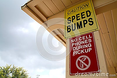 Caution Speed Bumps No Cell Phones During Pickup Sign Stock Photo
