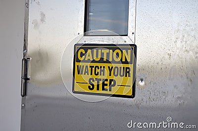Caution watch your step sign on door Stock Photo