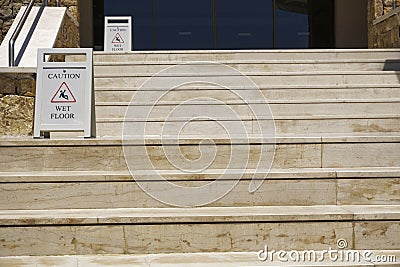 Caution wet floor warning signs on stairs. Stock Photo