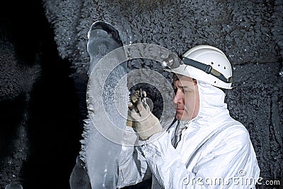 Cave explorer in the ice cave Stock Photo