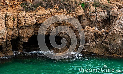 A cave hidden in the sea. Stock Photo