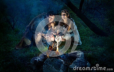 Cave people near bonfire Stock Photo