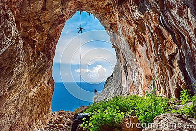 Cave rappel, sea at the background Stock Photo