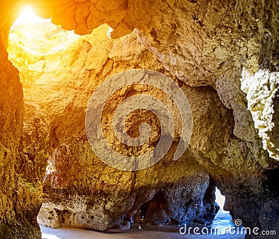 Cave rock formation on Alvor beach and view of sea Stock Photo