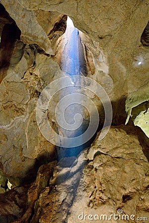 Sunlight beaming into Belfry Cave of the Capricorn Caves system Editorial Stock Photo