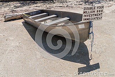 CAYE CAULKER, BELIZE - MARCH 2, 2016: Small boat with a sign double your investment at Caye Caulker island, Beli Editorial Stock Photo