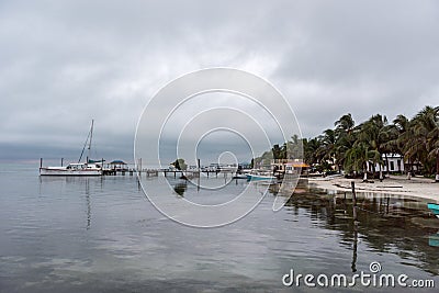 CAYE CAULKER, BELIZE - NOVEMBER 20, 2017: Caye Caulker Island in Caribbean Sea. Cloudy Morning And Calm Water in Pier. Editorial Stock Photo