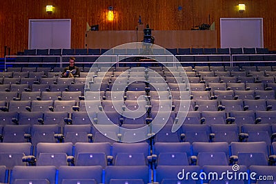 CCB concert hall audience with empty chairs, just one person sitting and a broadcast camera in Lisbon. Editorial Stock Photo