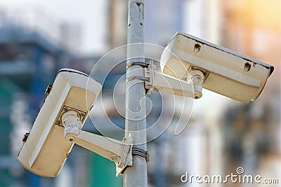 CCTV camera concept with refinery on background Stock Photo