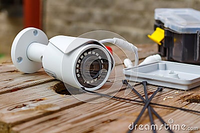 CCTV camera and expendable materials for mounting on a wooden surface Stock Photo